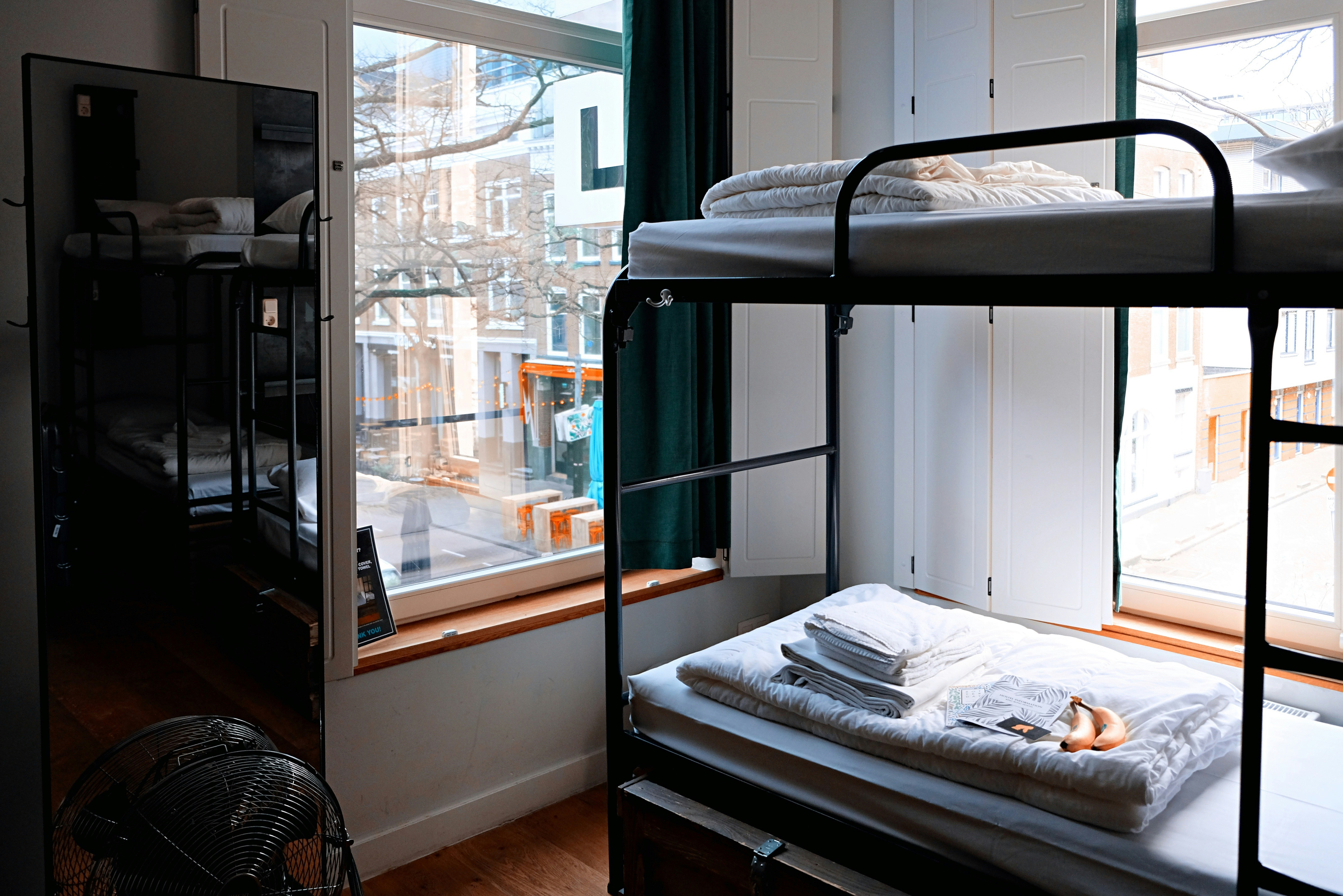 Well-organized college dorm room with two beds and study areas