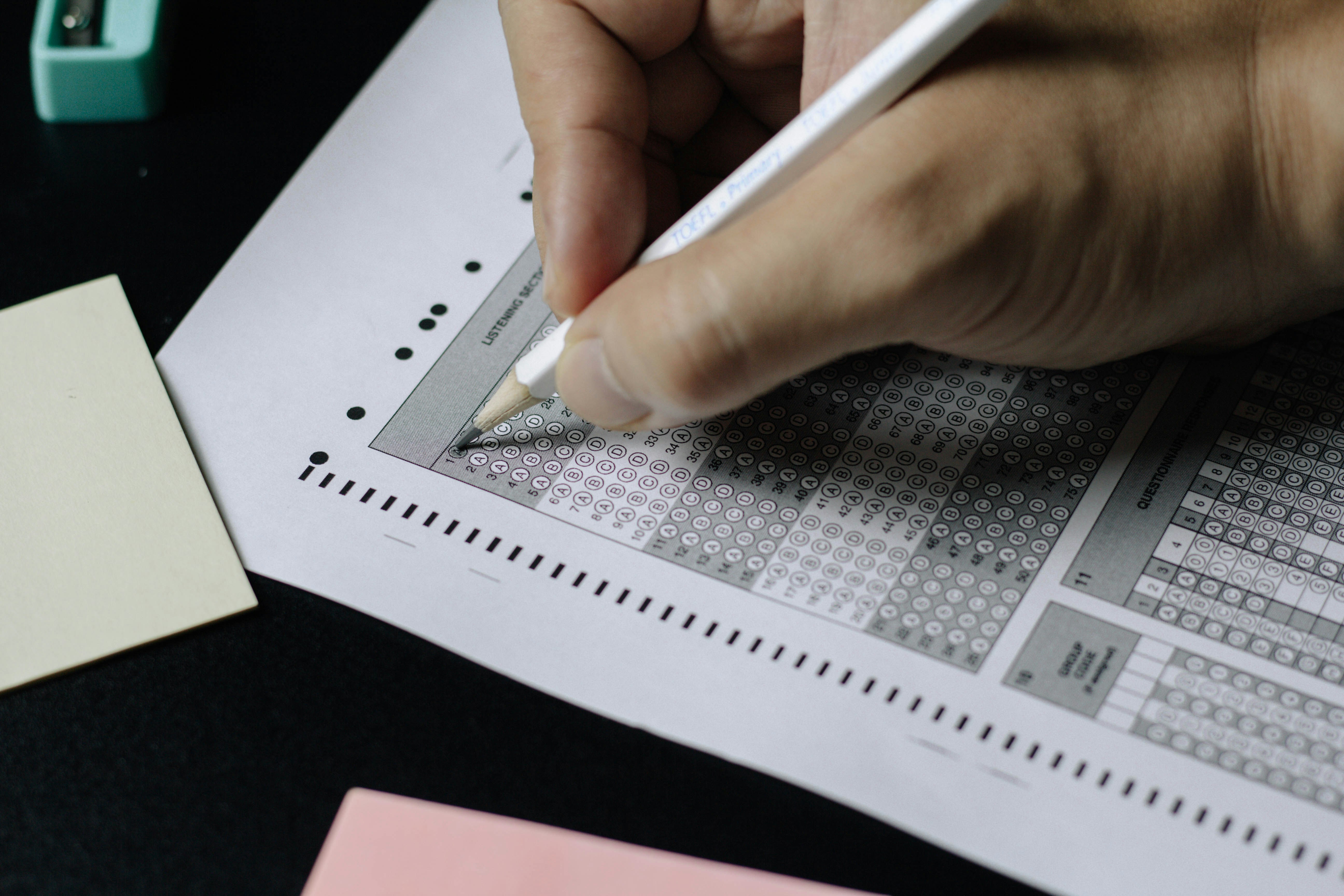 Student studying for standardized tests with books and calculator